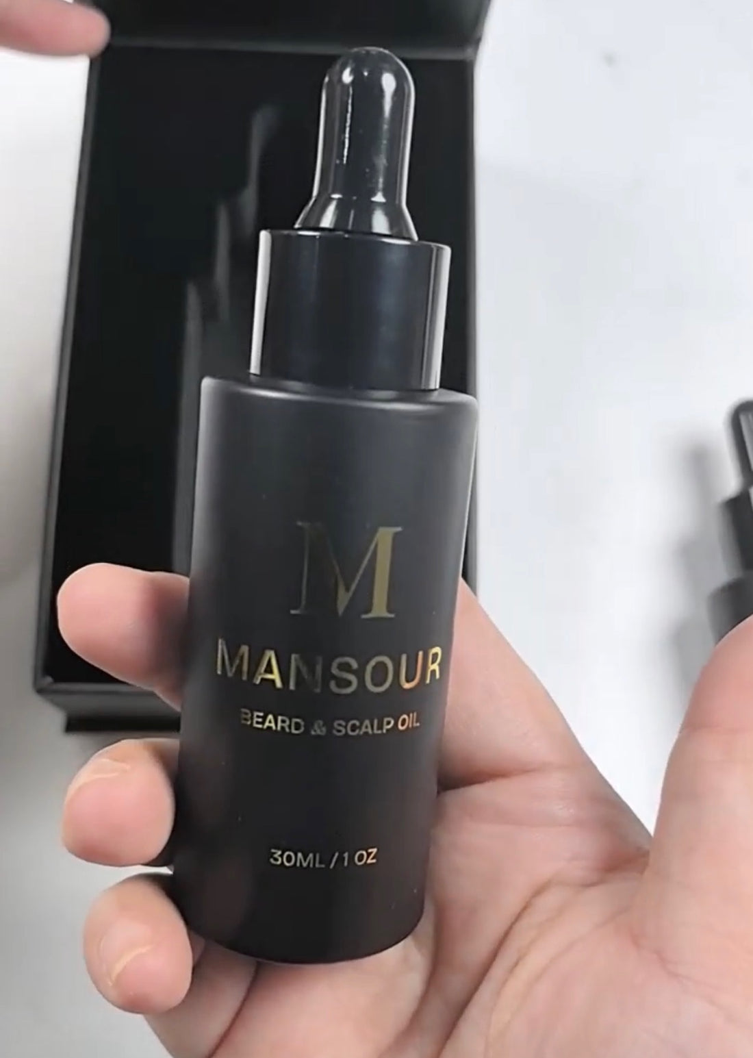 MANSOUR bottle in hand